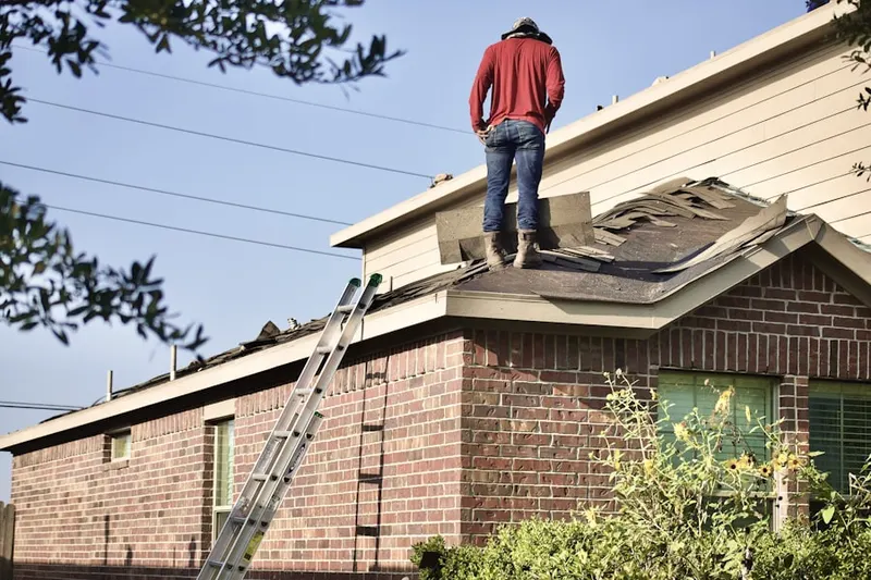 Professional roofer working on a residential roof in Deerwoods